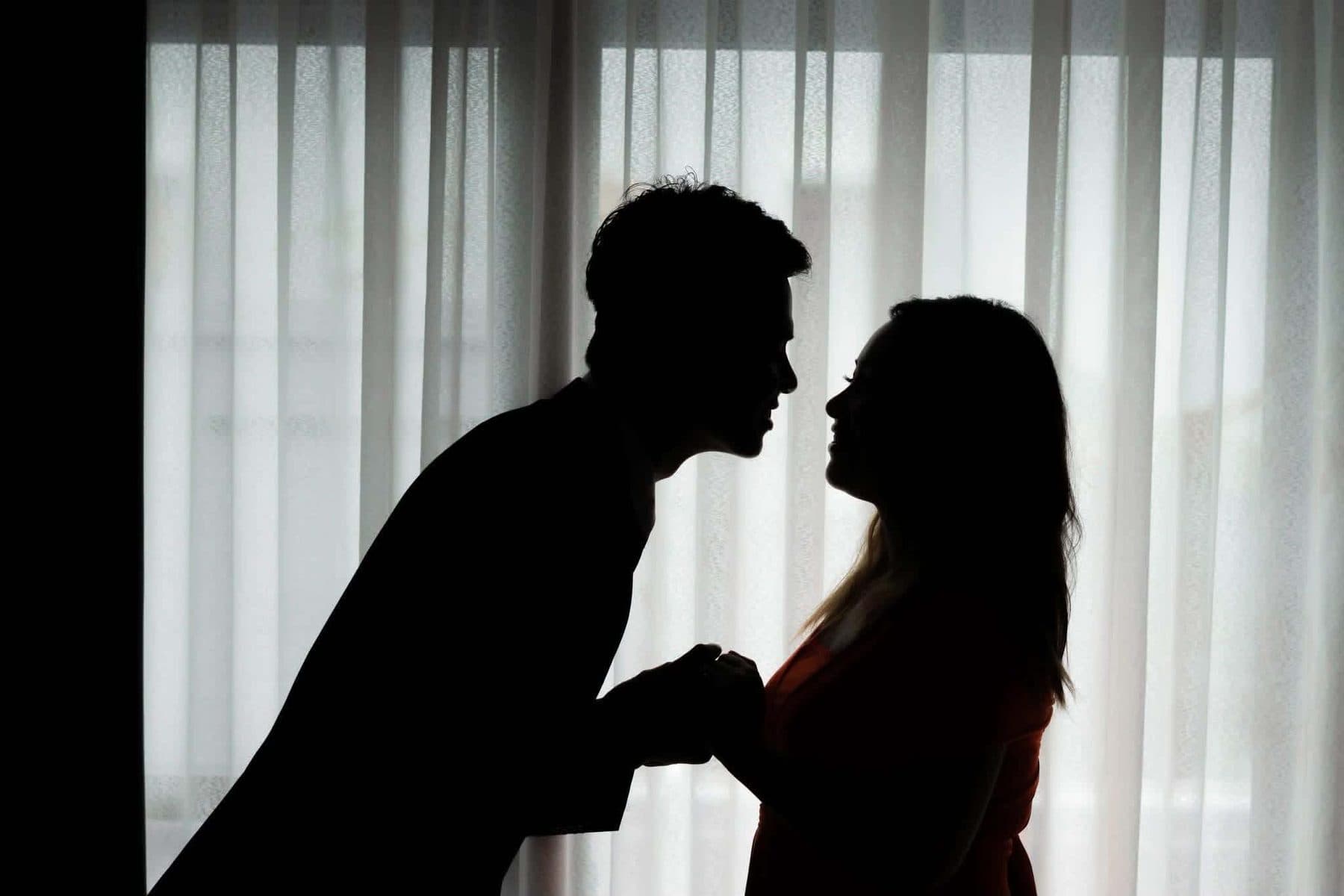 Couple in silhouette before the vows